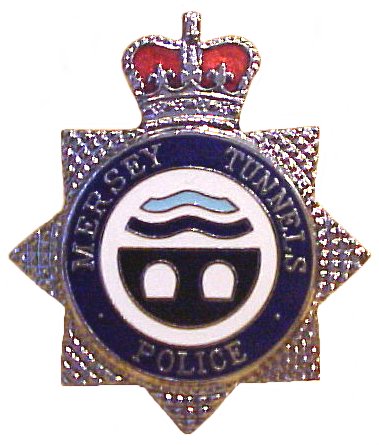 Mersey Tunnel Police Cap Badge
Cap Badge
All Ranks
1996 - To Date
The Mersey Tunnels logo in white and blue enamel surrounded by a dark blue enamel circle with the wording Mersey Tunnels Police in chrome relief. The whole is mounted on a chrome seven star surmounted with a Queens crown in chrome and red enamel.
Keywords: Mersey Tunnel Police Cap Badge