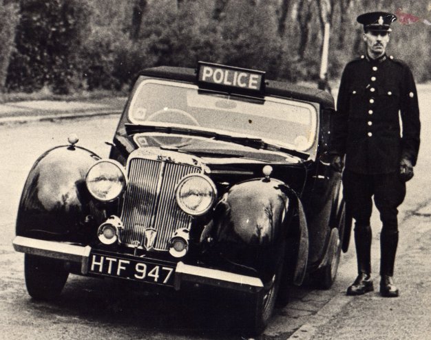 Police Constable 1963 Geoff Wood Lancashire Constabulary
Police Constable 1963 Geoff Wood (Picture taken 1947)
standing beside his new 1947 Triumph 1800 Roadstar
Submitted by Ray Ricketts

Keywords: Lancashire Triumph Roadstar vehicles