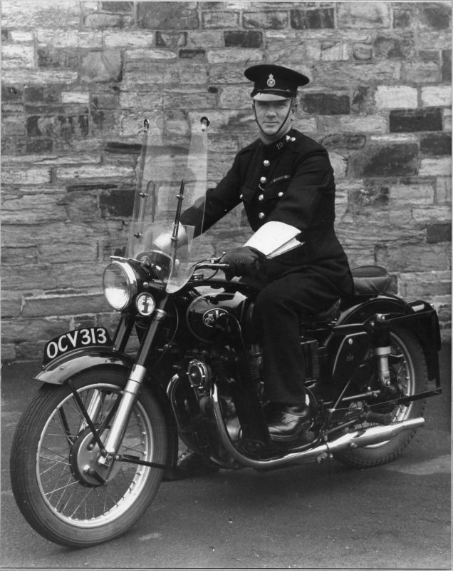PC 191 Vaskaby 'Mick' LESTER (wearing WW2 Star/Defence Medal/War Medal) 
He is riding an A.J.S. motorcycle and the photo is taken 1952/53 (tax disc says 1953)
It is apparently taken at Police HQ at Bodmin.
Photograph submitted by Ray Ricketts 

