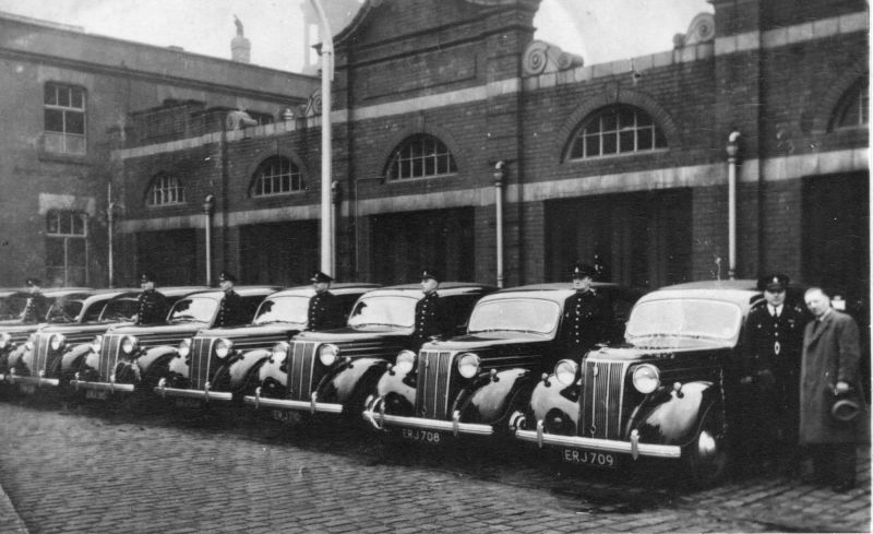 Salford police cars late 1940s
Fleet of Ford Pilots taken around 1950. Behind is the old Fire Station
PC116 Harry (Crash) Hardisty, last on right before the Inspector
Submitted by Rod Hardisty
