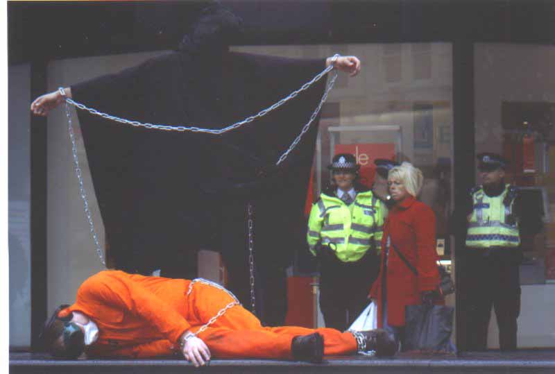Im Stood On The Right Watching Some Demonstrators
Picture was taken in Middlesbrough Town Centre, approx 2004. The demonstration was regarding the prisoners in Guantamano Bay. 
Keywords: Demonstrators
