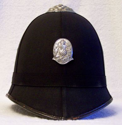 Edinburgh City Police Helmet, 1932 - 1951
Edinburgh City Police Helmet, 1932 - 1951. Cork helmet covered with smooth cloth in the Scottish style, plain cloth centre band, detailed chrome top rose with no ventilation holes (although the type with vent holes is known to exist. Scottish National Police Badge introduced in 1932 which superseded the Edinburgh City Police Coat of Arms. Two vent holes either side of the helmet 
Keywords: Edinburgh Headwear