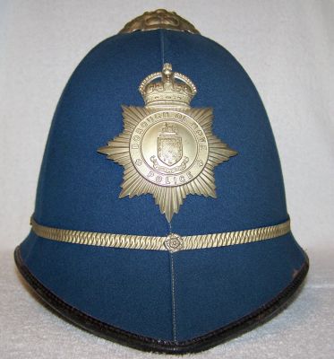 Hove Borough Police helmet; 1930's
Hove Borough Police helmet; 1930's, unusual light blue colour to distinguish Hove Borough officers from those from nearby Brighton. White metal detailed rose top, helmet plate and centre band

Keywords: hove helmet headwear