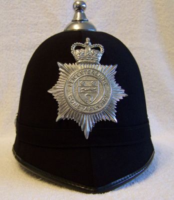 Leicestershire Constabulary Helmet; late 1970's
Leicestershire Constabulary Helmet; late 1970's, cork body with six panel smooth cloth covering, cloth centre band and chromed balltop, side roses and helmet plate

Keywords: leicestershire helmet headwear