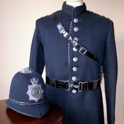 Metropolitan Inspectors No. 1 Dress, 1960's
Metropolitan Inspectors No. 1 Dress, 1960's, higher quality tunic with black braid at collar, cuffs, skirts and open edge. Worn with black patent leather Sam Browne belt with snake clasp. Inspectors helmet as detailed elsewhere
Keywords: metropolitan inspector uniform helmet Headwear