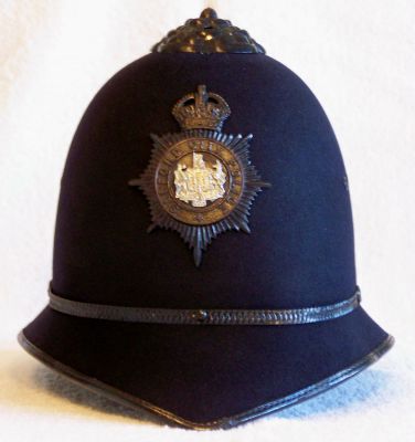 Salford City Mutual Aid Helmet, 1952
Salford City Mutual Aid Helmet, 1952, worn at the Queen's Coronation, one piece fibre construction made by Christies (very flimsy and distorts easily), black rosetop, thin metal centre band and small Salford City helmet plate worn quite high on the helmet. The black leather chin strap is made very short and even at the fullest adjustment barely gets below the wearers bottom lip.
Keywords: salford helmet Headwear