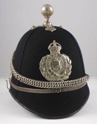 St Helen's County Borough Helmet
St Helen's County Borough Helmet, 1920's, cork four panel helmet with white metal centre band, balltop, chain and helmet plate. This helmet plate has been polished so often that it has worn through the metal in a few spots.
Keywords: helens, helmet