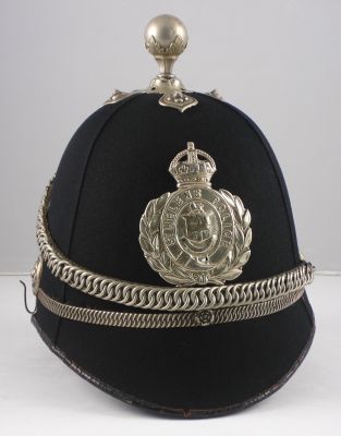 St Helen's County Borough Helmet
St Helen's County Borough Helmet, 1920's, cork four panel helmet with white metal centre band, balltop, chain and helmet plate. This helmet plate has been polished so often that it has worn through the metal in a few spots.
Keywords: helens, helmet