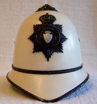 Stockport Borough White Helmet, 1949
Stockport Borough White Helmet, 1949, one piece fibre design with black rosetop, centre metal band and helmet plate, worn quite high on the helmet. Leather sweatband is impressed with Christys logo and the date '1949'
Keywords: stockport white helmet Headwear