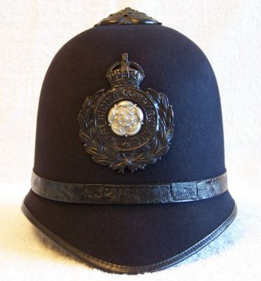 West Riding Helmet, circa 1920's
West Riding Helmet, circa 1920's, one piece construction in a 'bowler' style with black leather centre band, black flat rose top and helmet plate
Keywords: west riding helmet Headwear