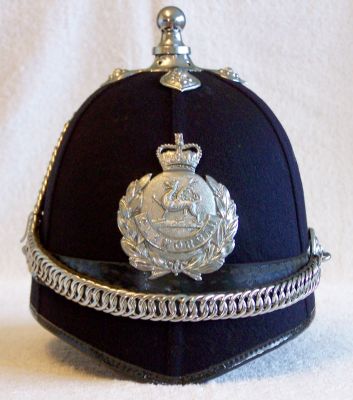 Glamorgan Constabulary Chained Helmet, post 1953
Glamorgan Constabulary Chained Helmet, post 1953, six panel design with black leather centre band, chrome balltop with cross base, ear rosettes and chinchain and helmet plate
Keywords: glamorgan helmet Headwear