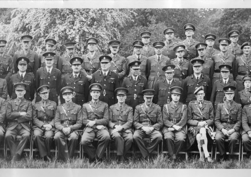 VARIOUS CHIEF CONSTABLES AT THE FIRST C.A.S.C. COURSE (FEB - MAY 1943)
C.A.S.C.: Civil Affairs Staff Course
The eight police officers shown are named as follows (L - R)
Det. Supt. T. Holmes; C/Cst. A.E. Young (Hertfordshire); C/Cst. H. Rawlings (Derby); C/Cst. S. Pickering (Stalybridge); C/Cst. R.T. Millhouse (Newark); C/Cst. C.E. Lynch Blosse (Leicestershire); C/Cst. C.G. Looms (Blackburn); C/Cst. E.R.B. Kemble (Warickshire)

This is a part of a large panoramic photo of the entire course.  The names are supplied on a separate sheet of paper.
Of particular interest is A.E. Young whose Wikipedia entry is very interesting, an important figure in the shaping of the modern police.
