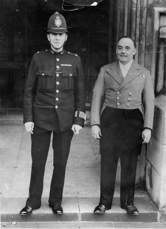 METROPOLITAN POLICE, PC 461A
I think this was taken at the entrance to the Savoy Hotel.
The PC is wearing a WW1 trio and the 'Maître-de' is wearing a WW1 trio plus the King's South Africa and the Queen's South Africa medals
