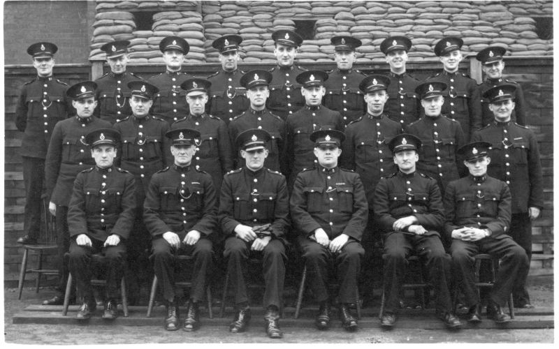METROPOLITAN POLICE V DIVISION, SPECIALS AND WAR RESERVE OFFICERS.
Back Row (L - R):
WR 20; 173; 146; 34; 13; 59; 45; 22; 41
Middle Row (L - R):
SC V; WR 32; 28; 147; SC V; WR 26; U/K; WR 17
Front Row (L - R):
WR 19; 55; Inspector; Inspector; WR 30; SC V

An individual portrait of the Inspector seated 3rd from the right has previously been submitted.
