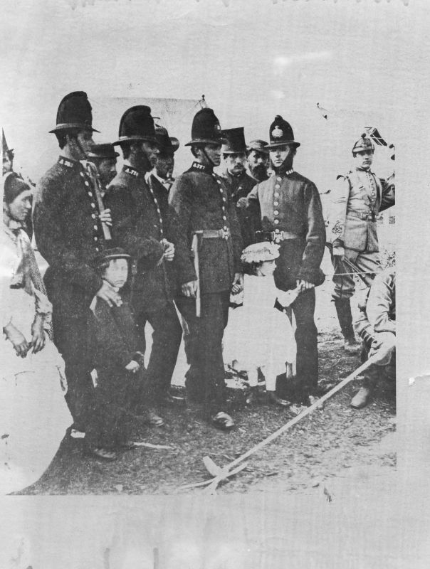 METROPOLITAN POLICE 'A' DIVISION (WESTMINSTER)
Copy of an old photo taken at a rifle match at Wimbledon (Wimbledon Cup?) circa 1867.
Nice image of the old style helmets and the first wreath style plate that did have numbers in the centre.
This image also appears at plate 69 in the book 'Victorian and Edwardian Crime and Punishment'.
