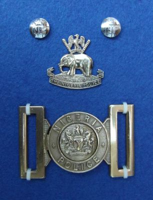 NIGERIA POLICE BADGES
A brass belt buckle and old brass cap badge.
