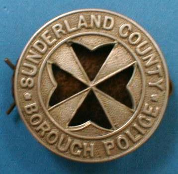 Sunderland Borough Police St John Ambulance Badge
St John Ambulance Badge issued to officers and worn on the left arm.  Quite a number of the badges worn by Sunderland officers had a red leather insert behind the cross.  Two lugs on rear which were secured by a split pin.
Keywords: Sunderland Borough Police