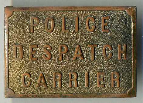 Police Despatch Carrier
Made of brass, it has two metal loops for a belt to go through.  Not sure which force or when they were used.
Keywords:  Buckle