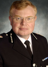 Dr Timothy Brain OBE QPM BA PhD FRSA Chief Constable Gloucestershire Constabulary
A student at the University of Wales, Aberystwyth, he read history, for a first class honours degree in 1975 and his PhD in 1983. He joined Avon & Somerset Constabulary in 1978 under the graduate entry scheme. Rising to chief inspector he joined Hampshire Constabulary as a Superintendent.  He became Assistant Chief Constable in the West Midlands Police in 1994, responsible for Community Affairs and later Operations.  He oversaw the policing of Euro ’96, counter terrorist operations, and the 1997 reorganisation of the force.  In 1998 he became Deputy Chief Constable of Gloucestershire. Dr Brain was appointed Chief Constable of Gloucestershire in 2001. 

As Chief Constable he has presided over the completion of the UK’s first Tri-service (Police, Fire and Ambulance) Emergency Control Centre, creating new specialist investigative units to combat serious & organised crime, and receiving the Investors In People award, becoming one of the few Police Forces to achieve the standard. In 2006 the Force moved into a new state of the art HQ, built under the Public Finance Initiative, being on time and under budget.    

A member of the Association of Chief Police Officers (ACPO) since 1994 he is their spokesperson on prostitution and related vice matters, leading the Government’s policy for child prostitution in 1998 and creating ACPO’s own prostitution strategy in 2004.  He chairs  ACPO’s Finance Business Area, and Chairs the Chief Police Officers’ Staff Association (CPOSA). 

He was awarded the Queen’s Police Medal in 2002. He was elected a Fellow of the Royal Society of Arts, Manufactures and Commerce (FRSA) in 2004 and a Companion of the Chartered Management Institute (CCMI) in 2007.  In 2008 he was awarded the OBE for services to the Police and the community in Gloucestershire.

His interests are history, music, rugby union and supporting Gloucestershire County Cricket.  He chairs the British Police Rugby & the British Police Symphony Orchestra. He is married with one son.
Keywords: Chief Constable Gloucestershire Constabulary