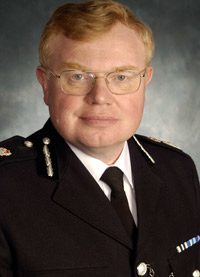 Dr Timothy Brain OBE QPM BA PhD FRSA Chief Constable Gloucestershire Constabulary
A student at the University of Wales, Aberystwyth, he read history, for a first class honours degree in 1975 and his PhD in 1983. He joined Avon & Somerset Constabulary in 1978 under the graduate entry scheme. Rising to chief inspector he joined Hampshire Constabulary as a Superintendent.  He became Assistant Chief Constable in the West Midlands Police in 1994, responsible for Community Affairs and later Operations.  He oversaw the policing of Euro ’96, counter terrorist operations, and the 1997 reorganisation of the force.  In 1998 he became Deputy Chief Constable of Gloucestershire. Dr Brain was appointed Chief Constable of Gloucestershire in 2001. 

As Chief Constable he has presided over the completion of the UK’s first Tri-service (Police, Fire and Ambulance) Emergency Control Centre, creating new specialist investigative units to combat serious & organised crime, and receiving the Investors In People award, becoming one of the few Police Forces to achieve the standard. In 2006 the Force moved into a new state of the art HQ, built under the Public Finance Initiative, being on time and under budget.    

A member of the Association of Chief Police Officers (ACPO) since 1994 he is their spokesperson on prostitution and related vice matters, leading the Government’s policy for child prostitution in 1998 and creating ACPO’s own prostitution strategy in 2004.  He chairs  ACPO’s Finance Business Area, and Chairs the Chief Police Officers’ Staff Association (CPOSA). 

He was awarded the Queen’s Police Medal in 2002. He was elected a Fellow of the Royal Society of Arts, Manufactures and Commerce (FRSA) in 2004 and a Companion of the Chartered Management Institute (CCMI) in 2007.  In 2008 he was awarded the OBE for services to the Police and the community in Gloucestershire.

His interests are history, music, rugby union and supporting Gloucestershire County Cricket.  He chairs the British Police Rugby & the British Police Symphony Orchestra. He is married with one son.
Keywords: Chief Constable Gloucestershire Constabulary