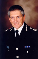 Meredydd Hughes QPM Chief Constable South Yorkshire Police
Meredydd Hughes joined the South Wales Constabulary in 1979, on leaving university. Whilst predominately serving in uniform operational duties at all levels, he has also worked as the Force Crime Prevention Officer; as an authorised firearms officer; as an IT project manager and on secondment to the HMIC at the Home Office.

He transfered to West Yorkshire Police in 1995 as a Superintendent with the post of Divisional Commander in the Calder Valley. This was followed by two years as the Commander of the Operational Support Division, where he was responsible for units such as the Air Support Unit, Search and Firearms Teams, and the Mounted Section. He was also Silver Commander at Leeds United FC, and led cross-border operations and major firearms incidents.

Promoted in 1999 to Assistant Chief Constable in Greater Manchester Police, he initially took responsibility for IT, Criminal Justice, and Communications. In September 2000, he took charge of the Uniform Operations Portfolio, and in that role led the policing of numerous public order and major sporting events, including two England football internationals, and commanded the successful planning and delivery of the Commonwealth Games.

He was promoted to Deputy Chief Constable in South Yorkshire in September 2002, and to Chief Constable in September 2004. Nationally, he plays the leading role for ACPO in the Uniformed Operations Business Area and is ACPO lead for support to the Olympic Games 2012.

He was awarded the Queen’s Police Medal in the 2006 New Year Honours.

Off duty, his hobbies include rock climbing and mountaineering, running, and mountain biking.
Keywords: Chief Constable South Yorkshire Police