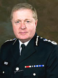 Sir Ian Blar QPM Commissioner Mertopolitan Police Service
Sir Ian Blair, born 19 March 1953, was educated at Wrekin College Shropshire and Harvard High School Los Angeles. At Christ Church Oxford, he gained a Second Class Honours Degree in English Language & Literature. 

Joining the Metropolitan Police in 1974 under the graduate entry scheme, he served in both uniform & CID in central London. In 1985, as a Detective Chief Inspector he took charge of the CID at Kentish Town. In 1988, as a Superintendent, he managed the MPS Crime Investigation Project redesigning the purpose and structure of CID offices in London.

In 1991, he was promoted to Chief Superintendent and appointed Staff Officer to Her Majesty's Chief Inspector of Constabulary, based at the Home Office.

Returning to the Metropolitan Police in 1993, he took charge of Operation Gallery, then the largest police corruption enquiry in London.

In 1994, he became Assistant Chief Constable of Thames Valley Police. Responsible for territorial policing he took charge of policing the Newbury by-pass protests. In 1996, he was made responsible for personnel matters. In 1997, he became designated deputy to the Chief Constable of Thames Valley Police. In January 1998 he became Chief Constable of Surrey.

In February 2000, he returned to the MPS as Deputy Commissioner, supporting the Commissioner in the overall management, he has also dealt with; change management, anti-corruption work, diversity and for information management. One of the foremost in-service advocates of police reform he was instrumental in the development of Police Community Support Officers. He is also one of the main spokesmen for the police service on criminal justice reform. In February 2005, he succeeded Sir John Stevens as the Metropolitan Police Commissioner.

In 1999, he was awarded the Queen's Police Medal for Distinguished Service and he was awarded a knighthood in the Queen's Birthday Honours, 2003, for his services to policing.
Keywords: Commissioner Metropolitan Police Service