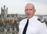 John McNab Deputy Chief Constable Grampian Police
Having graduated a Bachelor of Science with Honours in Town and Country Planning from Heriot-Watt University, Edinburgh, John McNab, worked briefly as a company manager before joining Fife Constabulary in 1986.

Born in Kirkcaldy, he began his policing career in the nearby Levenmouth and Glenrothes areas of Central Fife in uniform and CID duties before being promoted to temporary sergeant on the Accelerated Promotion Course in 1992.  He served in various posts: Traffic; CID; Uniform Beat Patrol; and other specialist roles, while rising through the ranks, before being promoted to Superintendent at Her Majesty's Inspectorate of Constabulary, leading on Force primary inspections and concluding a thematic report on the progress of Best Value within the Police service in Scotland.

In September 2002, Mr McNab returned to Fife Constabulary to head a rapid implementation project to provide an interim centralised call handling solution for the Force prior to the opening of a new build Force Contact Centre.  On successful completion of the project in January 2003, he took territorial command of the Central Division of Fife Constabulary before progressing to participation on the 2004 Strategic Command Course at Bramshill.

On his return to Force, Mr McNab was temporarily promoted to Assistant Chief Constable, (Operations) which concluded in March 2005 at which point he took up the position of Head of Operational Support.

In April 2005, he was successful in his application for the post of Assistant Chief Constable within Grampian Police and took up this position in July of that year, with responsibility for Community Partnerships; Operational Policing; Crime Management; and Operational Planning and Support.

On 14 May 2007, following the promotion of the then Deputy Chief Constable Patrick Shearer, to Chief Constable of Dumfries & Galloway Constabulary, Mr McNab temporarily assumed the role of Deputy Chief Constable.

On 10 October 2007, Mr McNab was formally appointed Deputy
Keywords: John McNab Deputy Chief Constable Grampian Police