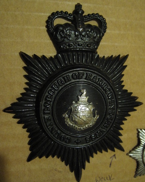 Night Service Helmet Plate Bi Metal Blackened Brass QC 
Night Service Helmet Plate Bi Metal Blackened Brass QC used from circa 1953 until 1st April 1969 when force merged with Lancashire Constabulary
Keywords: Night Helmet Plate Queens Crown QC Black Barrow Furness