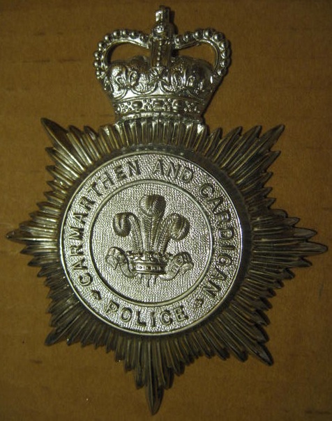 Helmet Plate Carmarthenshire and Cardiganshire Police QC 
Chrome Helmet Plate worn 1958 to 1968 when the force amalgamated with Mid-Wales Constabulary and Pembrokeshire Constabulary to form Dyfed-Powys Constabulary.
Keywords: Helmet Plate Carmarthenshire and Cardiganshire Police QC 