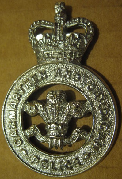 Cap Badge PC's and Sgt's
Chrome Cap Badge worn for 1958 to 1968 when the force merged with Mid Wales Police and Pembroke  Constabulary to form Dyfed-Powys Police.
Keywords: Cap Badge QC Carmarthenshire and Cardiganshire Police