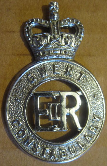 Larger PC's Cap Badge
Chrome Cap Badge worn post 1953 by PC's two copper lug fixings east west
Keywords: Cap Badge PC's QC Gwent Constabulary