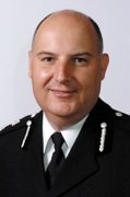Simon Ash Chief Constable Suffolk Constabualry
Simon Ash is the Chief Constable of Suffolk Constabulary. Simon Ash is Suffolk Constabulary's Chief Constable. He was born in Kent and, after studying at Birmingham University, joined Kent County Constabulary in 1982.There, he held various positions through the ranks until 1993 when he was promoted to the rank of Chief Inspector Operations in Folkestone. Two years later he was promoted to the rank of Superintendent and became Head of Personnel and then spent two years as Area Commander of Maidstone and Malling.In 2001 Simon joined Hertfordshire Constabulary as Assistant Chief Constable, Operations, and held that position until 2003 when he was promoted to Deputy Chief Constable. As Deputy Chief Constable he was responsible for Organisational Intelligence, Human Resources and Corporate Communication.On June 4th, 2007 he joined Suffolk Constabulary as Chief Constable.He has a BA Hons Degree in Geography, MA in Organisational Management and a Diploma in Applied Criminology and Police Studies from Cambridge University.Simon is married and has two children. His interests include golf and he is a keen football supporter.
Keywords: Simon Ash Chief Constable Suffolk Constabualry