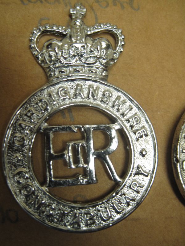 Cap Badge PC's and Sgt's
Chrome cap badge officially worn until 31st May 1958 when the force amalgamated with Carmarthenshire Constabulary but it was several months before the new cap badge was issued to all members
Keywords: Cap Badge QC Cardiganshire Constabulary