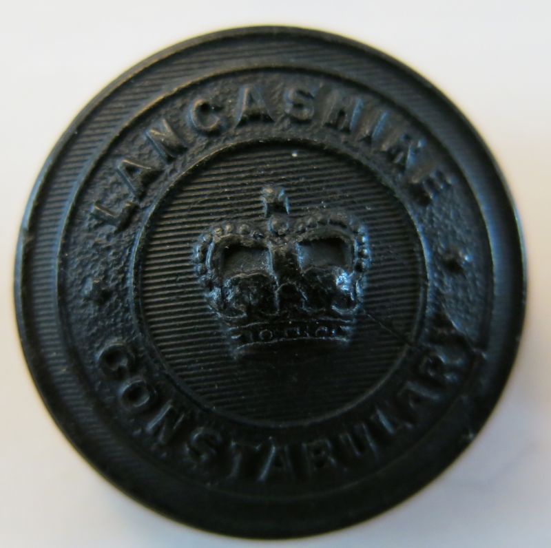 Lancashire Constabulary Black Tunic Button QC 
Worn in the period from the early 1950's when the buttons changed to a St Edwards Crown in the early 1950's with ascension of Queen Elizabeth II to the present.
Keywords: Lancashire Constabulary Black Tunic Button QC 