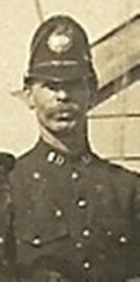 Police Constable Sharpness Docks, near Berkeley, Gloucestershire
This is the only picture I have ever seen showing the insignia to this very small police force. 
SD Chromed letters to collar, and repeated in the centre of Black 'laurel wreath' style circular KC helmet plate. For some reason the Constable has hooked up his leather chin strap behind the crown of the badge, very scruffy!
