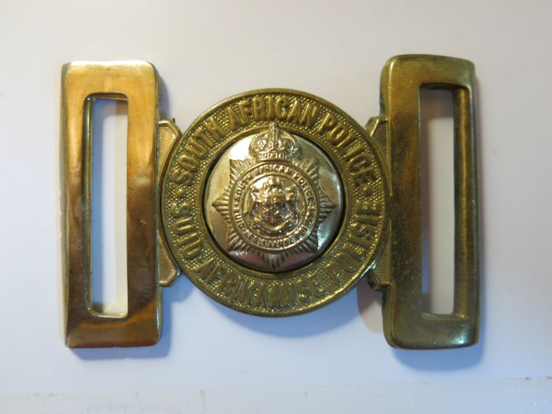 Brass Belt Buckle worn by European members of the South African Police from 1926 to 1931
European members of the SA Police wore Brass Insignia until 1977 when all races wore insignia in a "gilt" finish. This belt buckle was worn after the change over from Dutch to Afrikaans as the second official language in 1925, It was worn until 1931 when the  Afrikaans spelling of the word "Polisie" was deemed to be correct and taken into general use.
Keywords: South African Police Brass belt buckle 1926 to 1931