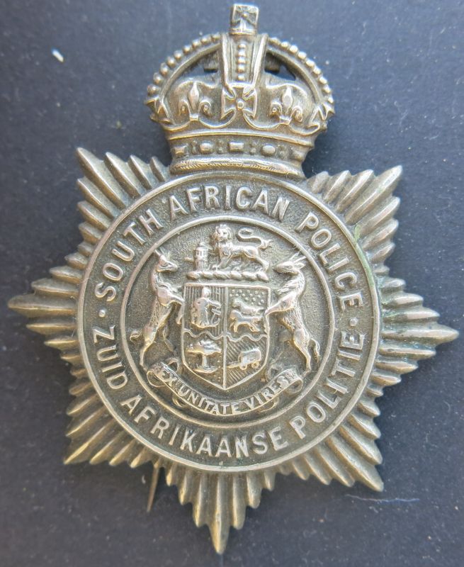 Cap Badge worn by Non-European members of the South African Police from 1913 to 1926
Non-European members of the SA Police wore White Metal or Chrome Insignia until 1977 when all races wore insignia in a "gilt" finish. This Cap Badge was worn from 1913 to 1926 following the second official language, Dutch, changing to Afrikaans in 1925. The words 'Zuid Afrikaanse Politie' changed to 'Suid Afrikaanse Poliesie'.
Keywords: Cap Badge Non-European members South African Police 1913 to 1926